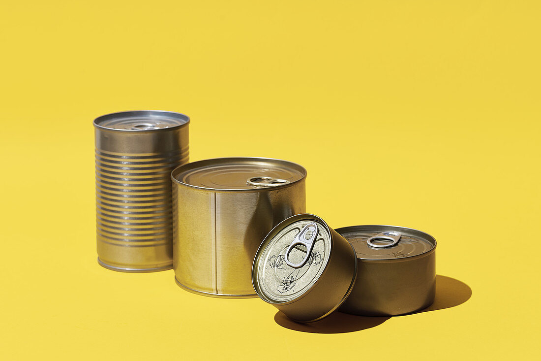 Various tins on a yellow surface