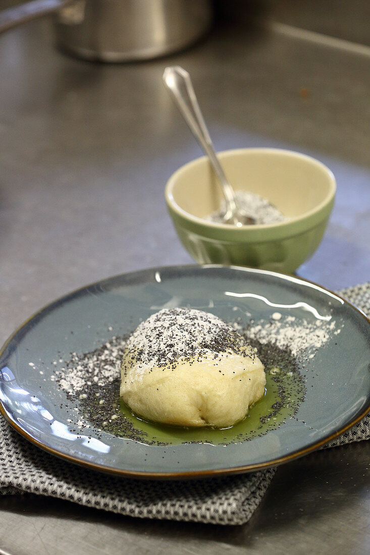 Germknödel (steamed, sweet yeast dumpling) with stewed plums