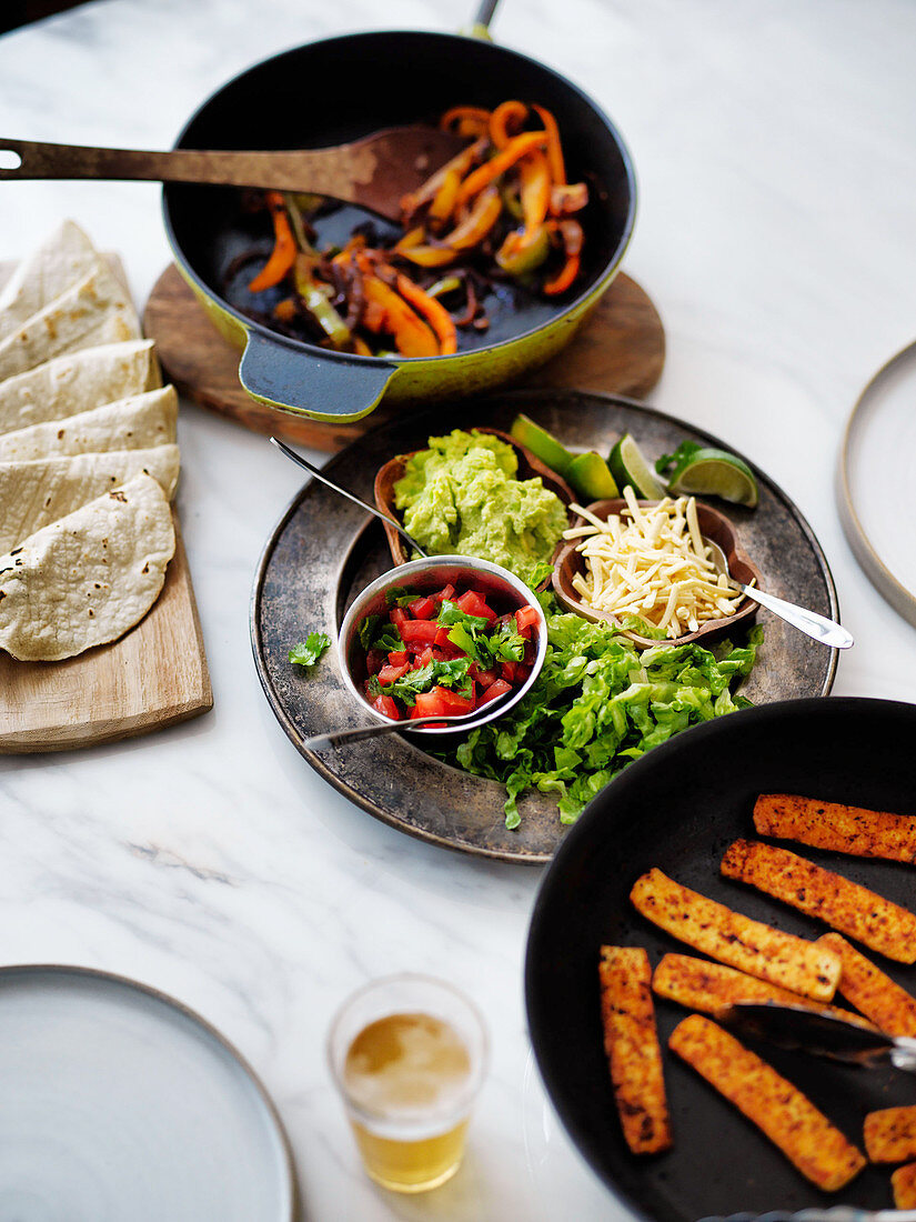 Mexican fajitas meal with dishes to make your own tacos