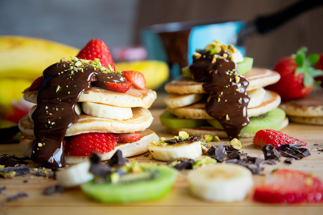 Pancakes with kiwi, strawberries, banana, chocolate and pistachios