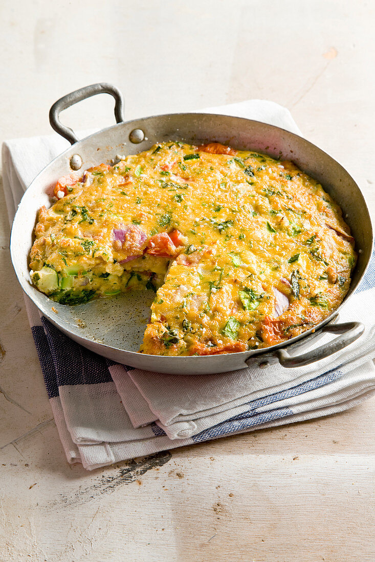 Frittata with zucchini, tomatoes and herbs