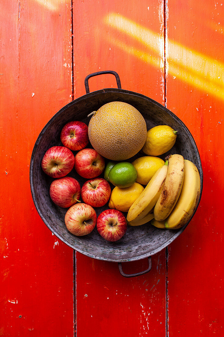 Obstschale mit Äpfeln, Zitronen, Bananen und Melone