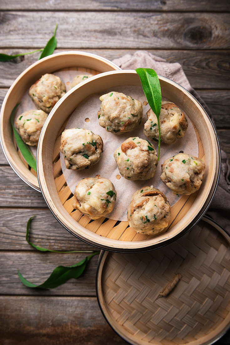 Vegan wild garlic bread dumplings made in a bamboo steamer