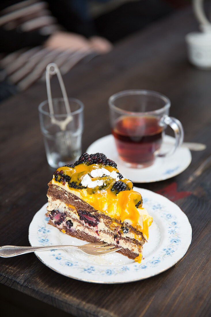 A slice of blackberry cake and a cup of tea
