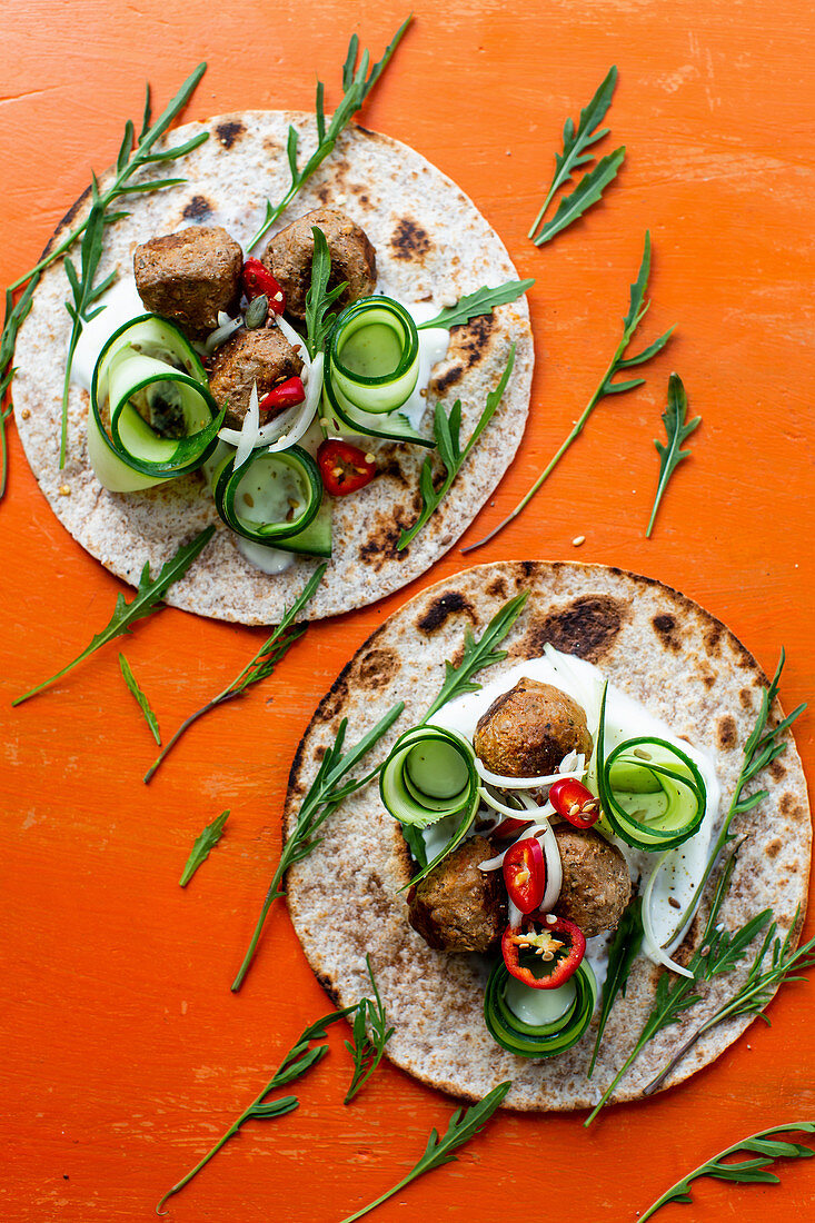 Wraps with spicy meatballs, cucumber and rocket