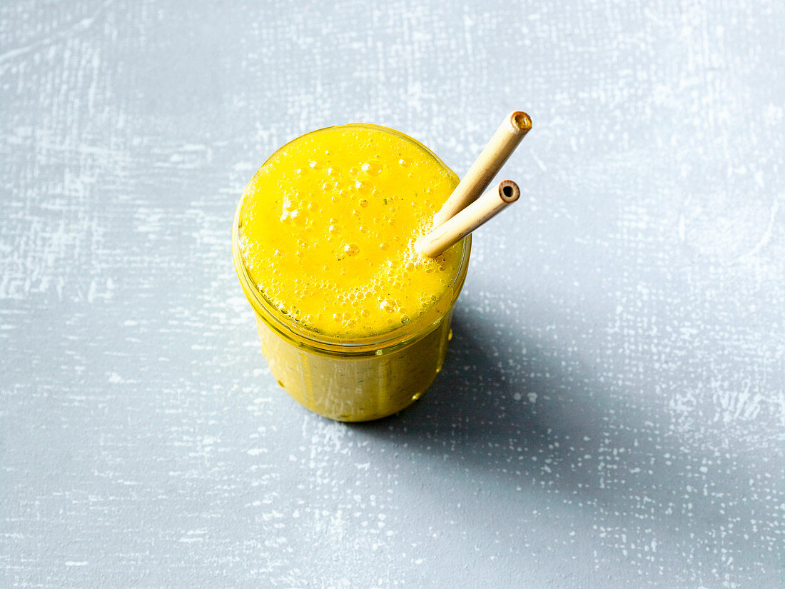 An orange and mango smoothie with turmeric