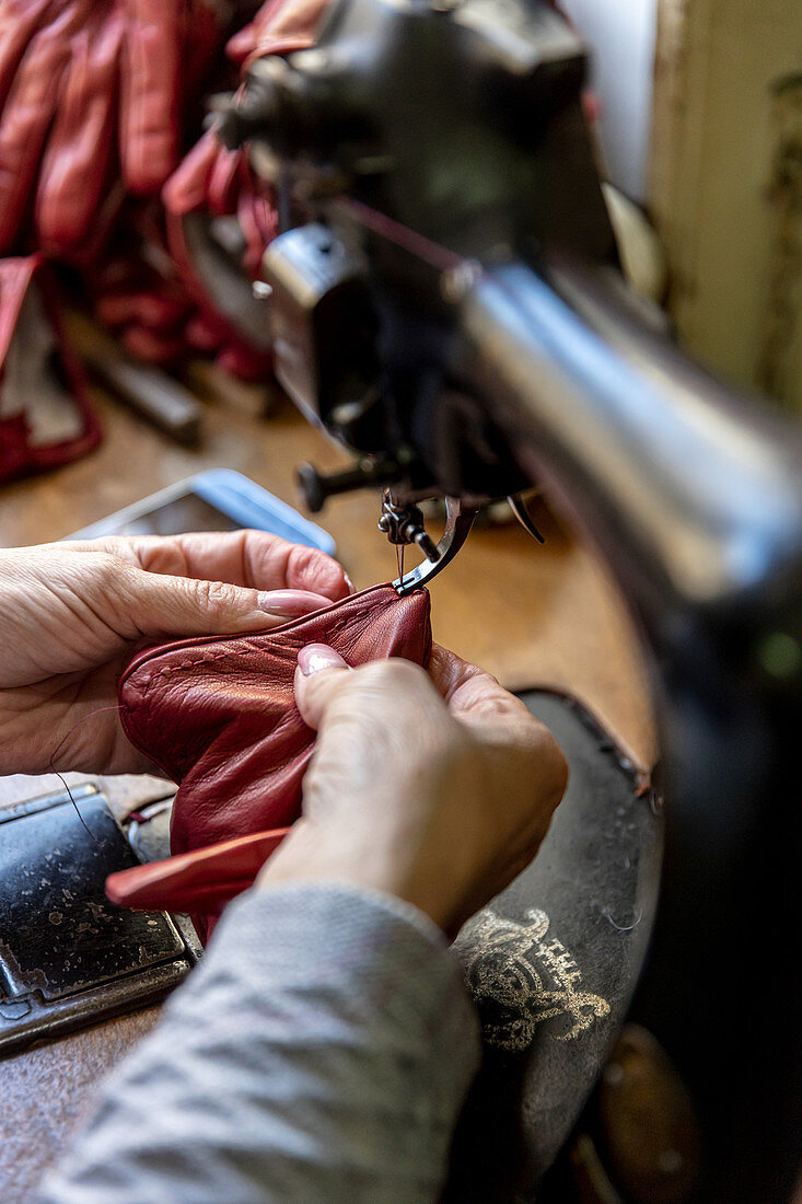 A leather glove being made in a tailor's workshop