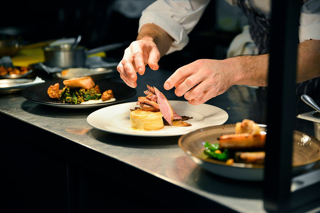 Chef plating Food in Restaurant
