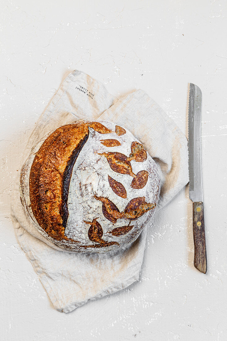 Round sourdough loaf on white background