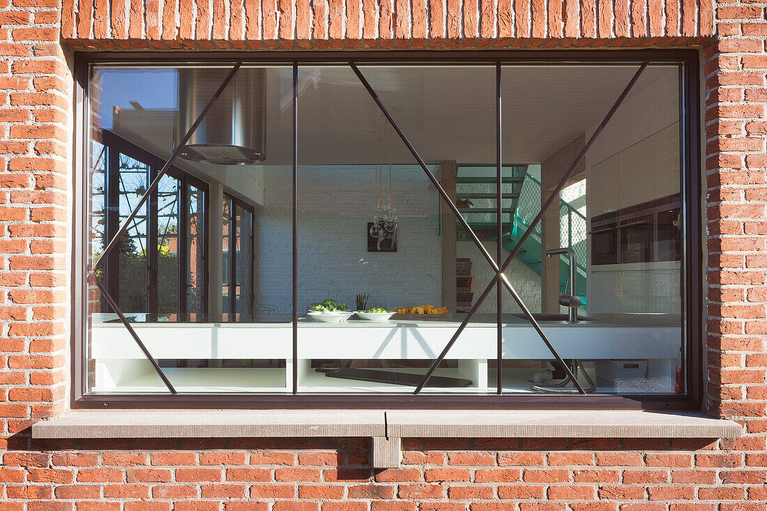 View of modern living space from outside through window