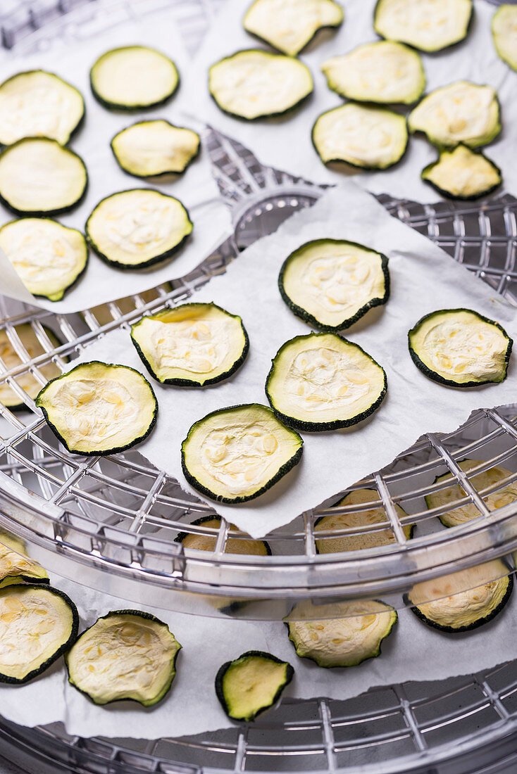 Courgette slices being dried in a dehydrator