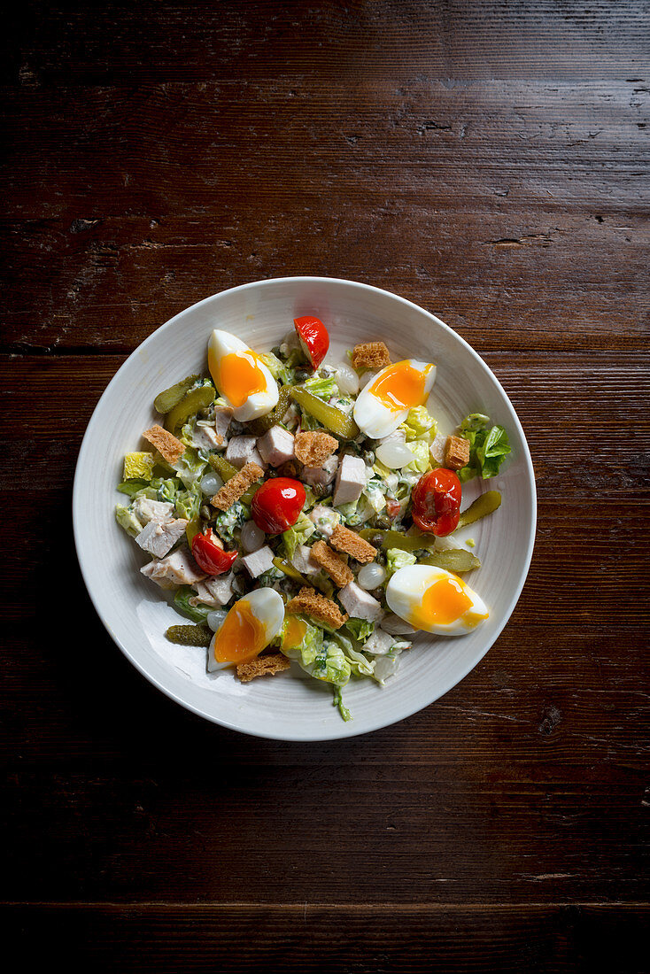 Mixed salad with boiled eggs and bread