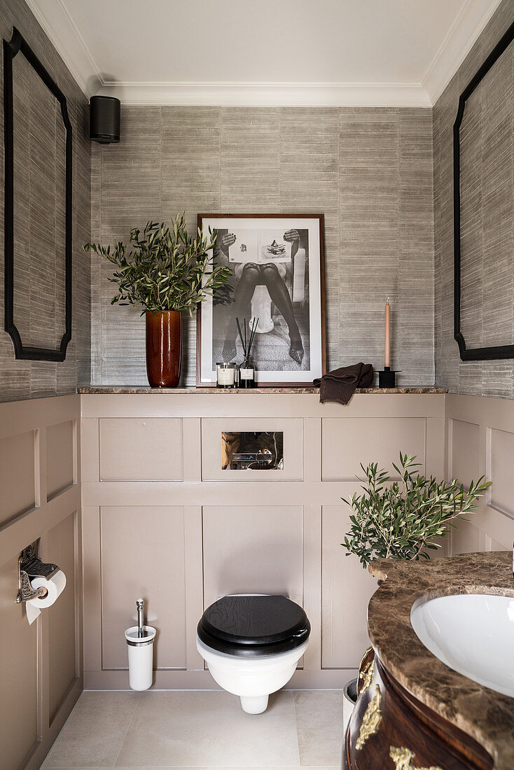 Toilet in classic bathroom with panelled wainscoting