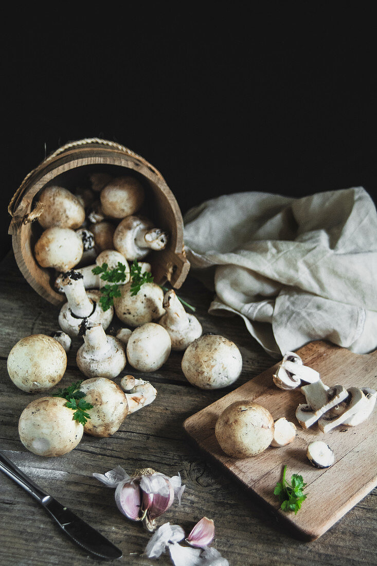 Mushrooms champignon on the wood table