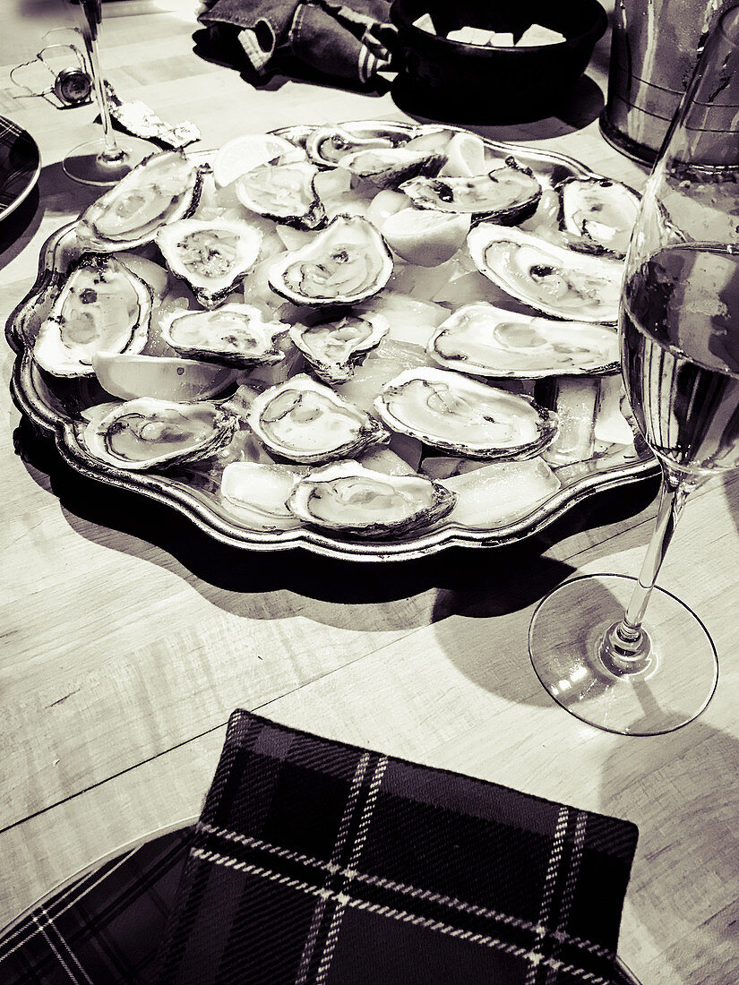 Fresh oysters on a serving platter with champagne