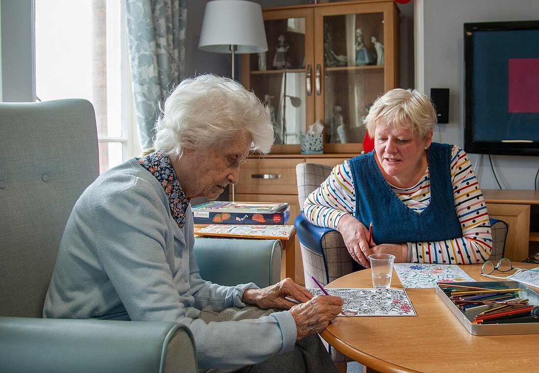 Care home resident and her daughter painting