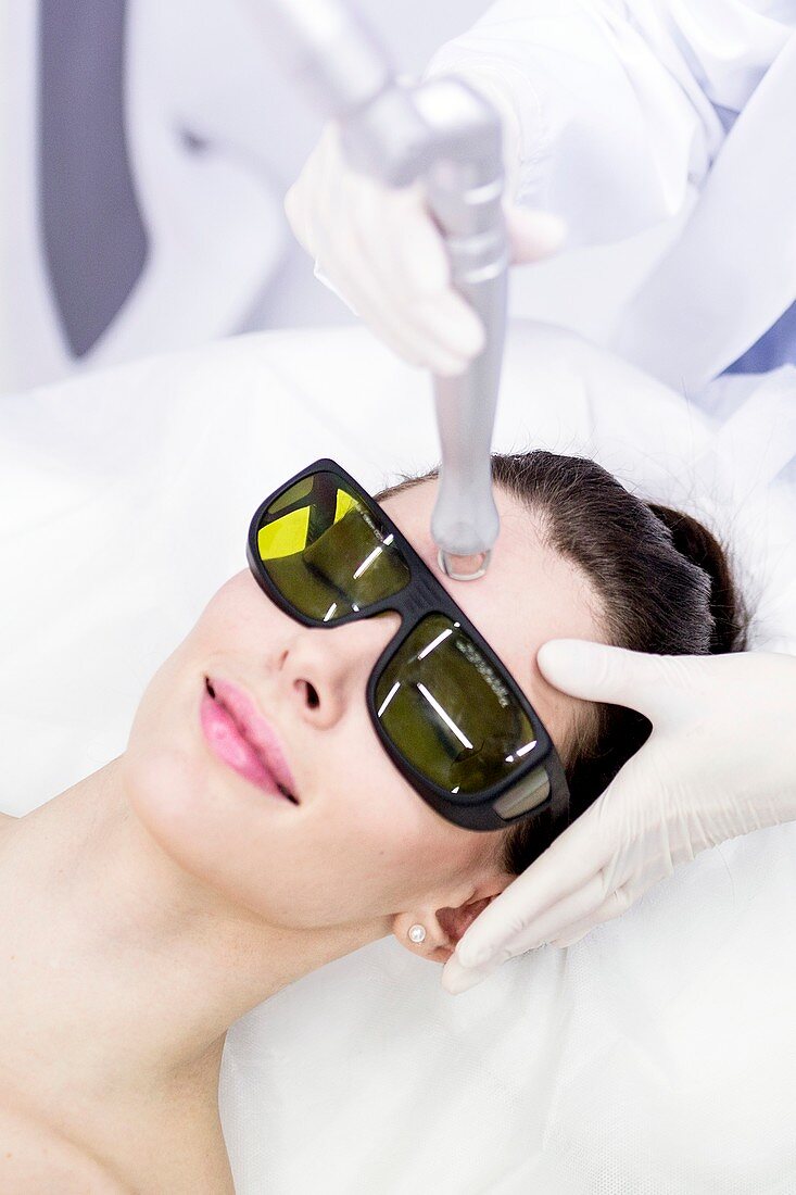 Beauty technician using laser treatment