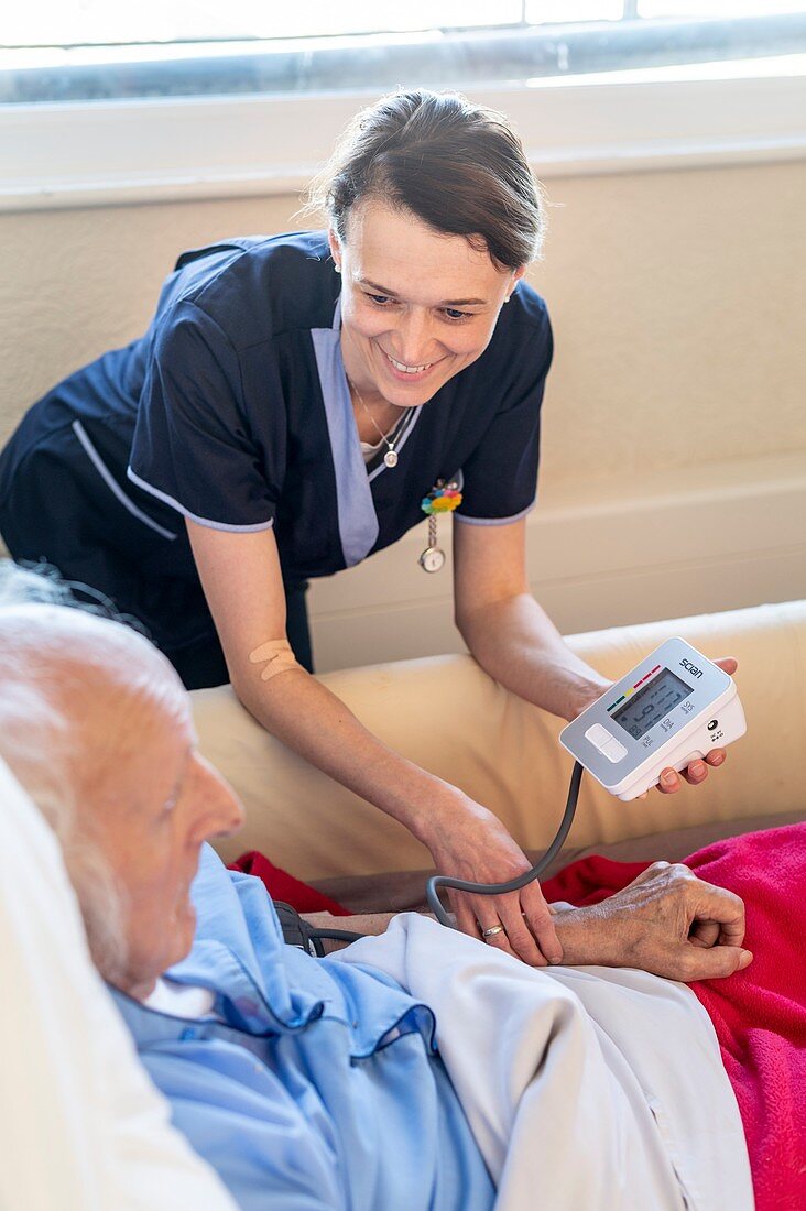 Male care home resident blood pressure test