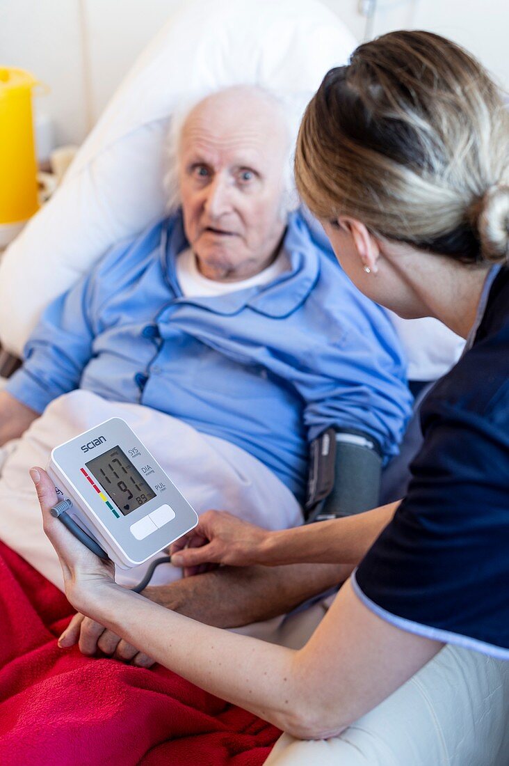 Male care home resident blood pressure test