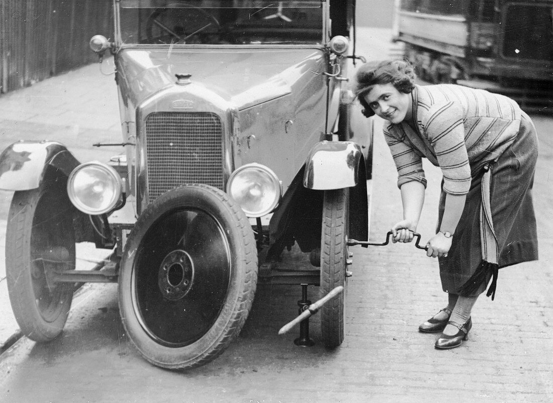 Ivy Cummings changing a tyre, London, c1925