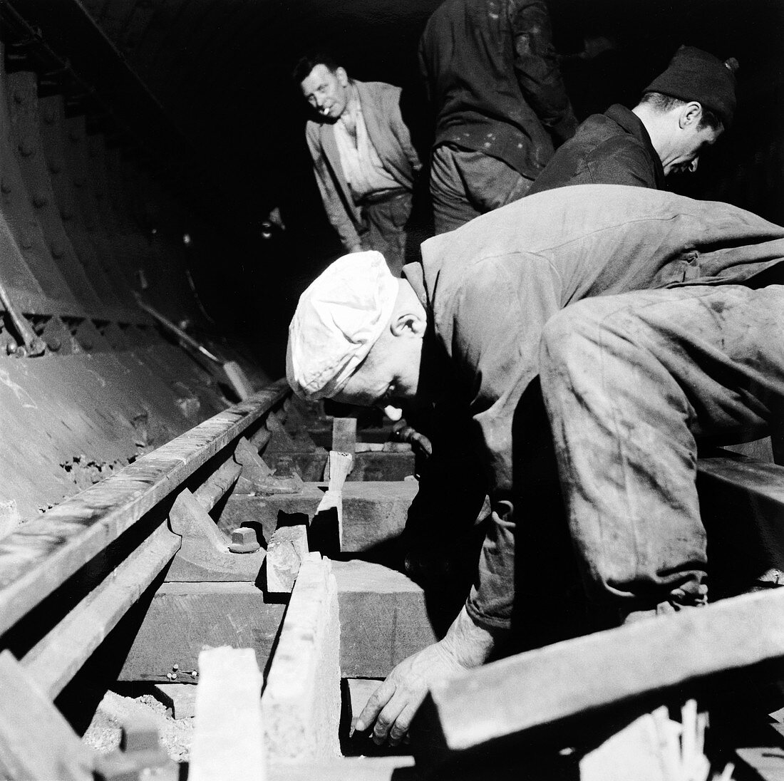 Repairing underground train tracks, London, 1955
