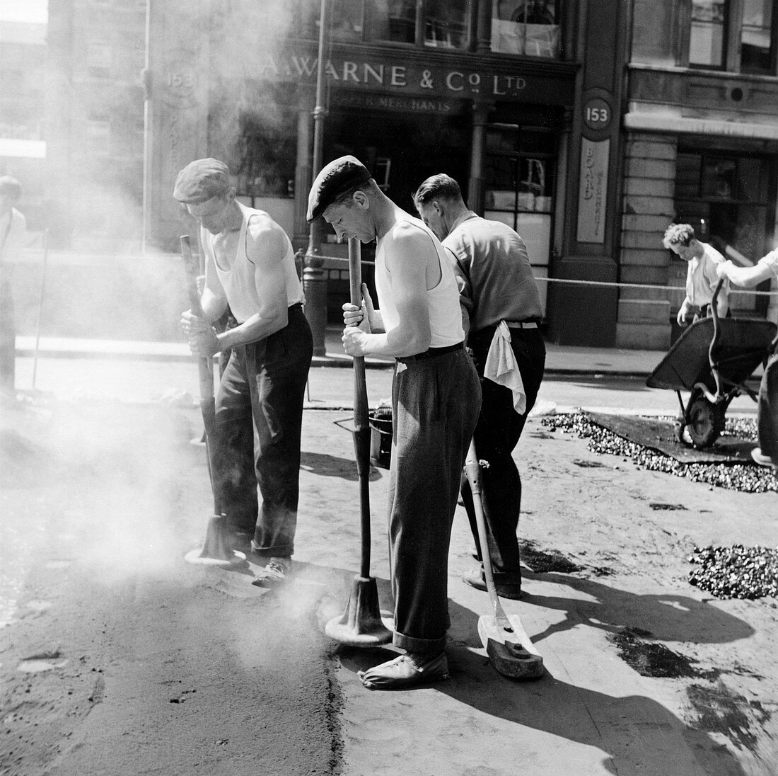Workers repairing Queen Victoria Street, London, 1955