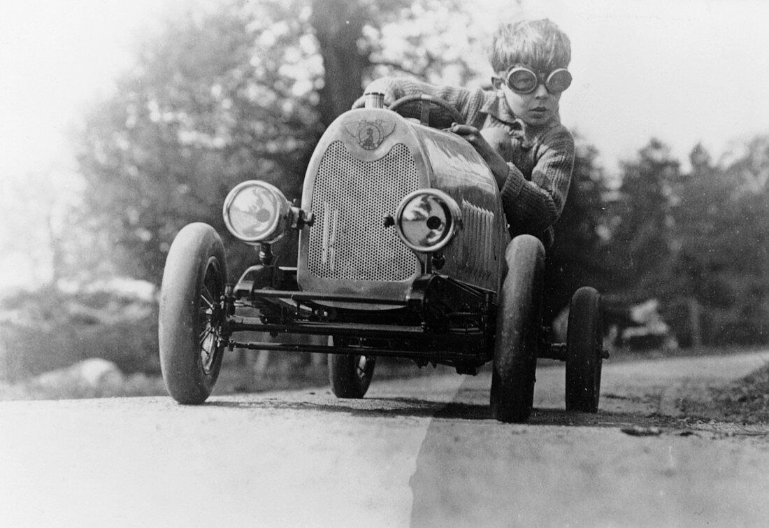 Boy in a pedal car