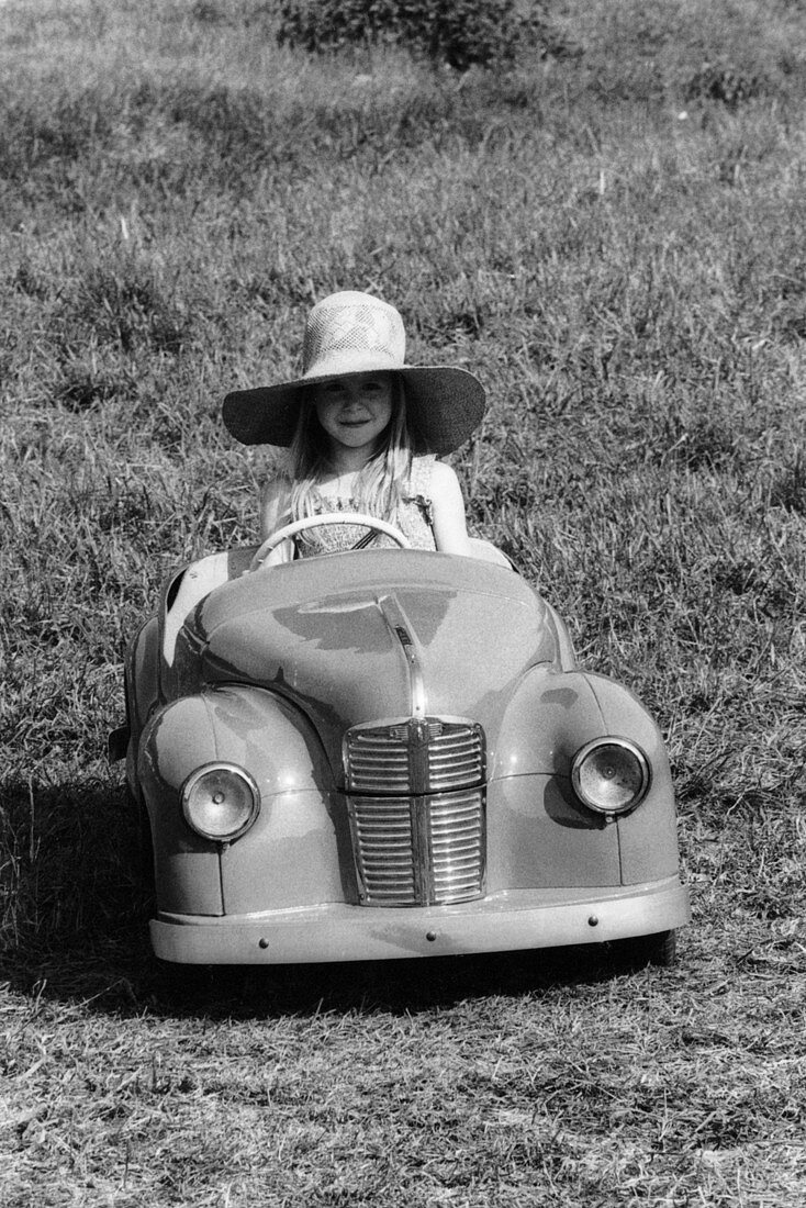 Girl in a 1948 vintage Austin J40 pedal car
