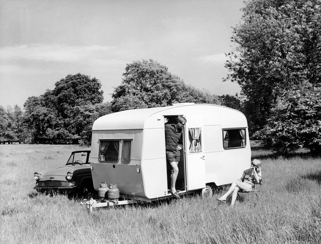 Couple on holiday with their 1963 Sprite Alpine caravan
