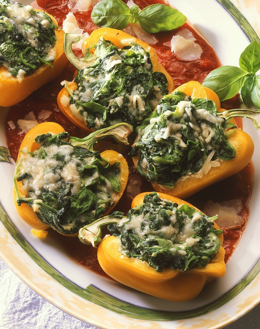 Peppers stuffed with spinach and parmesan on tomato sauce