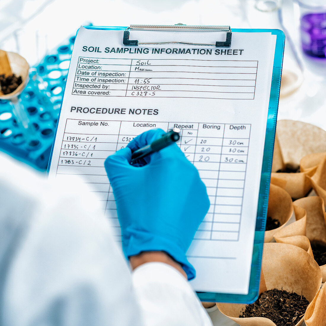 Soil scientist taking notes in laboratory