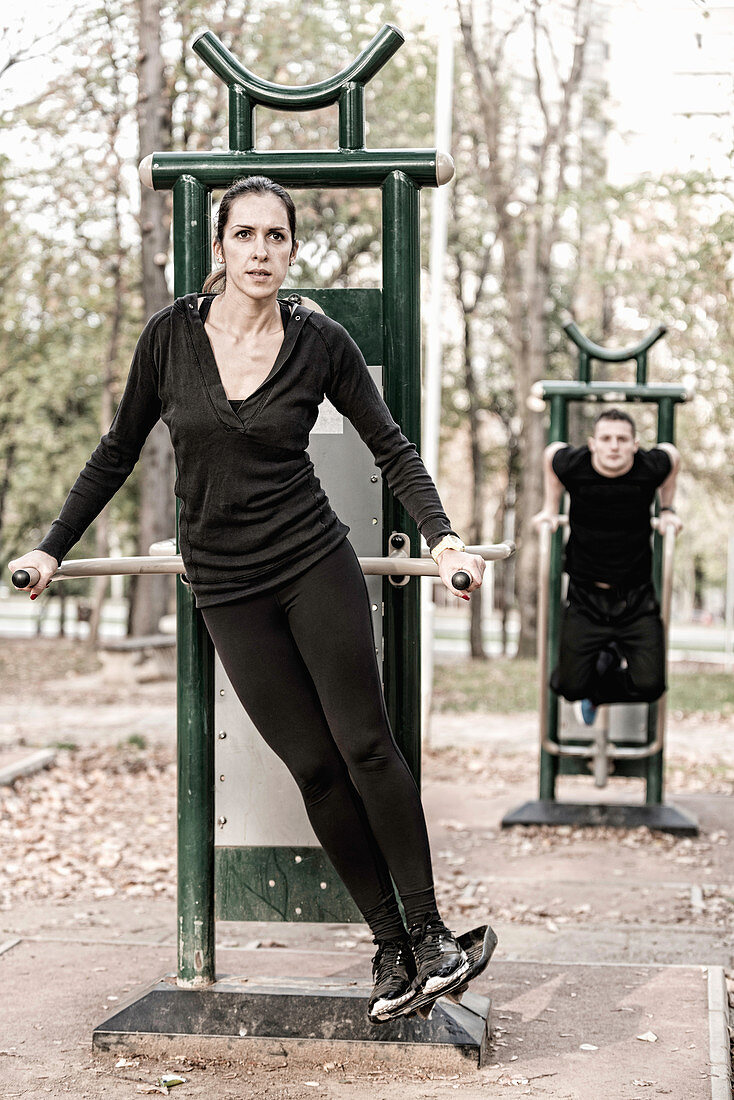 Couple exercising in public outdoor gym