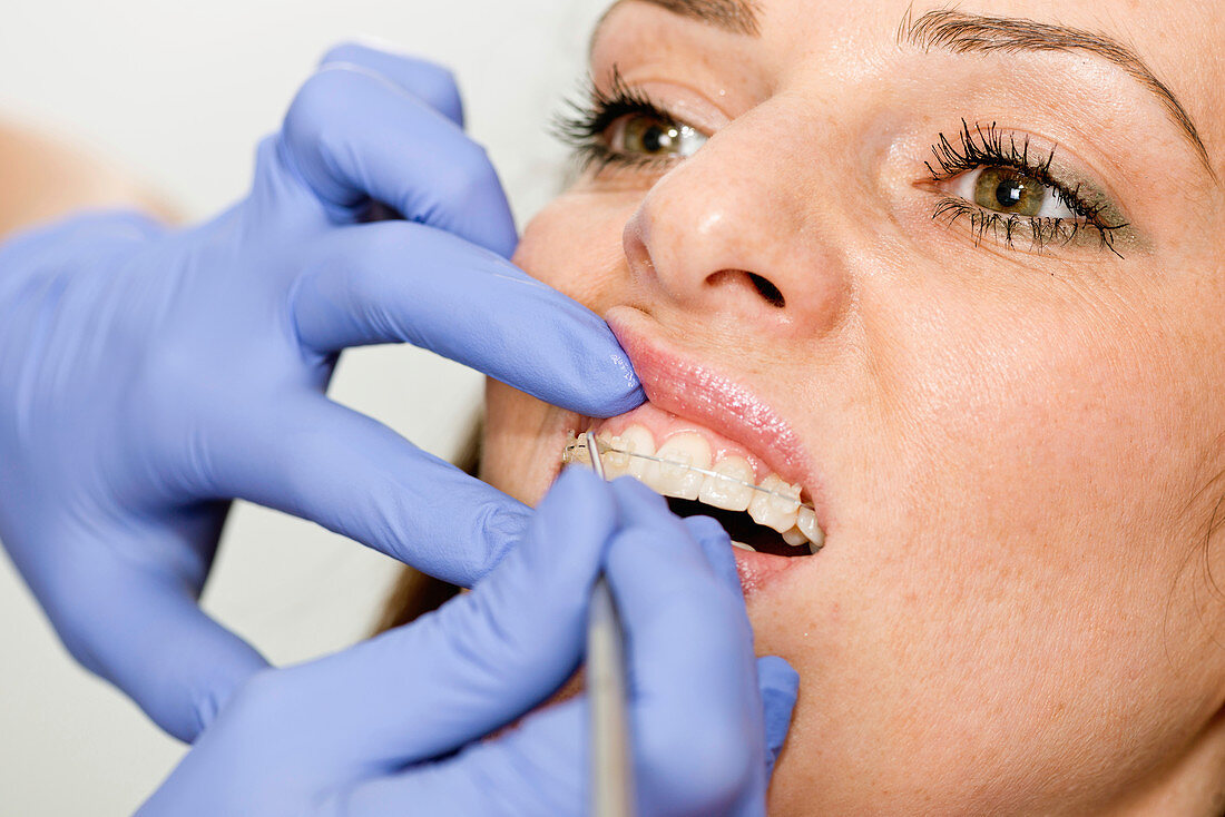 Orthodontist tightening braces