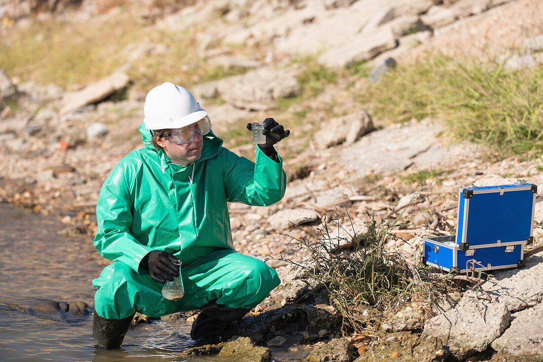 Inspector with samples of polluted water