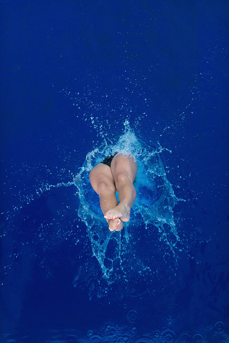 Female diver entering water