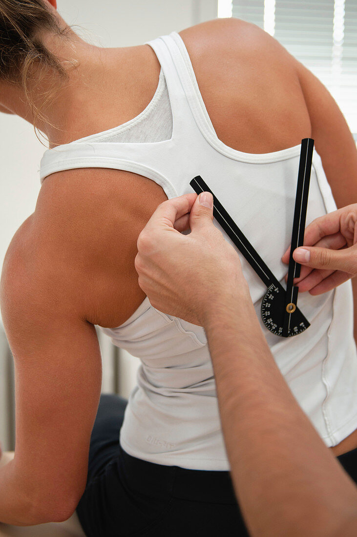 Physiotherapist measure back flexion