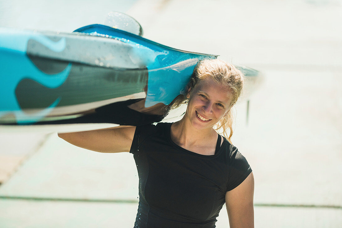 Woman carrying her kayak