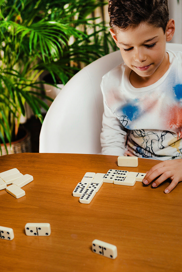 Schoolboy playing dominoes