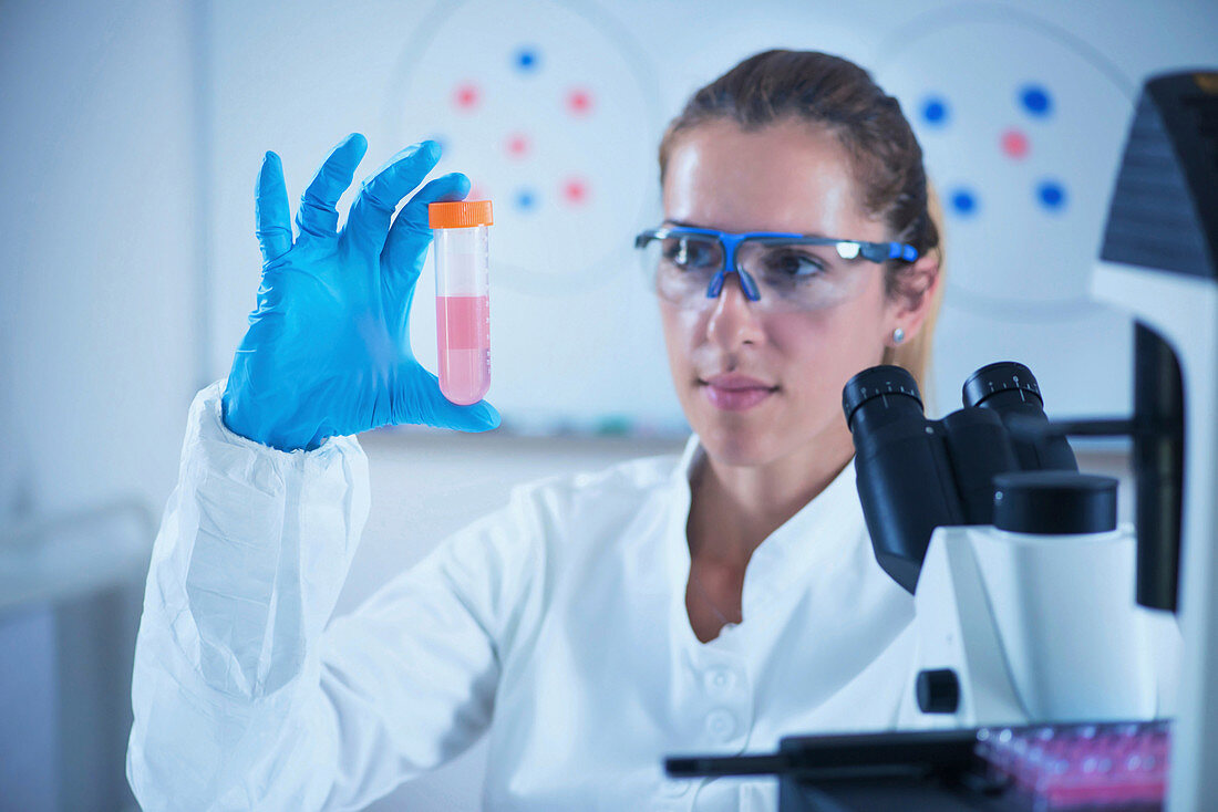 Scientist holding liquid sample