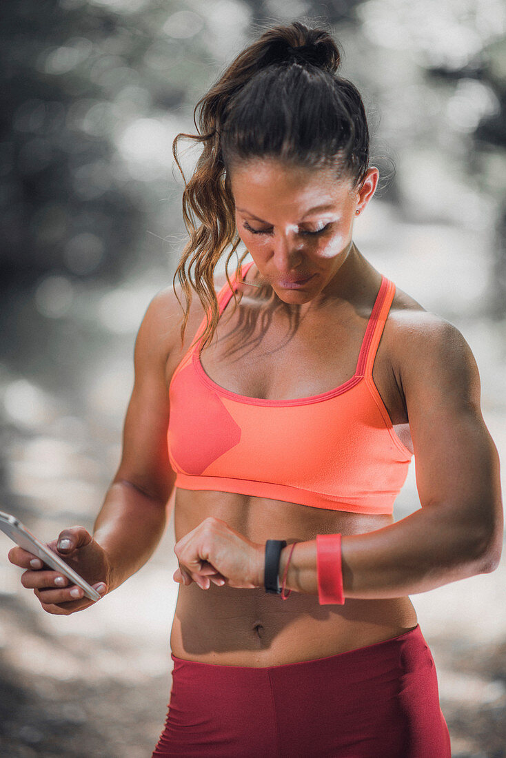 Woman looking at smartwatch during workout