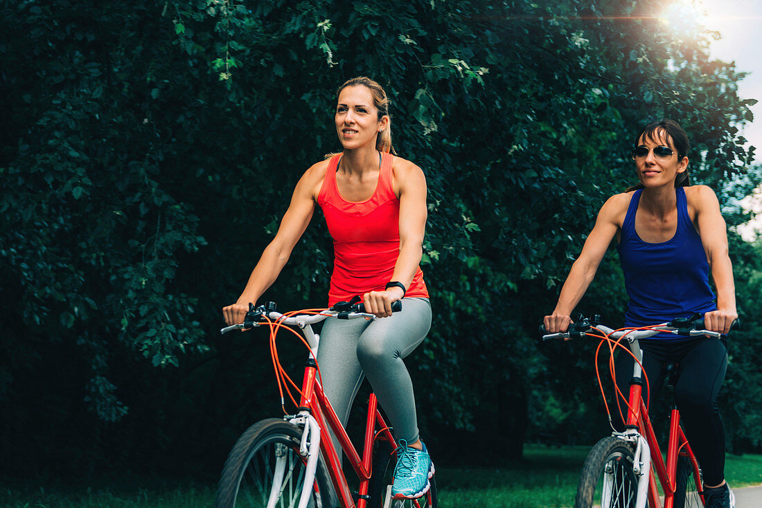 Two women cycling together