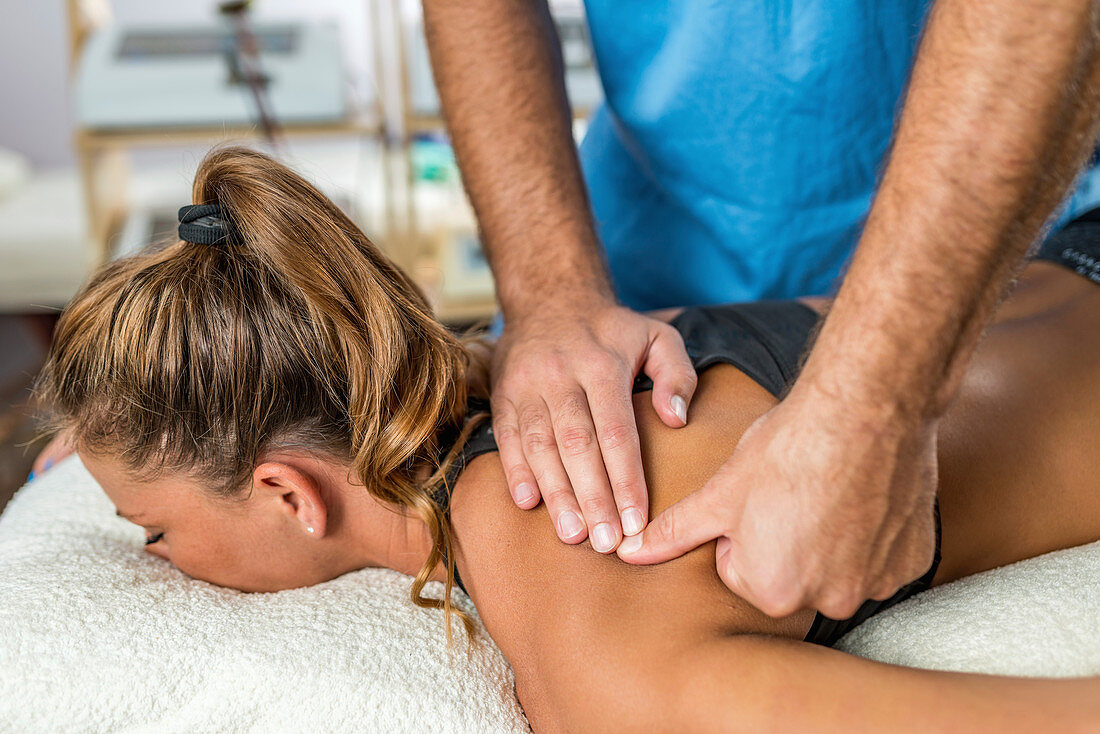 Osteopathist treating woman's back