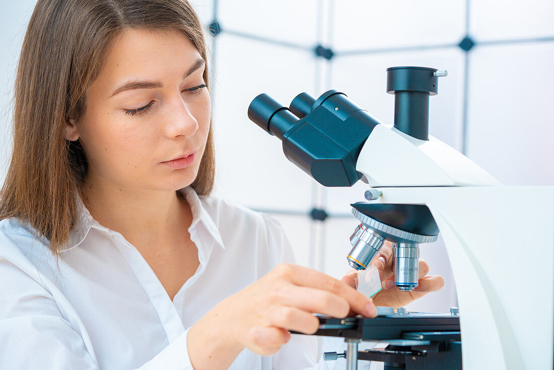 Researcher using microscope