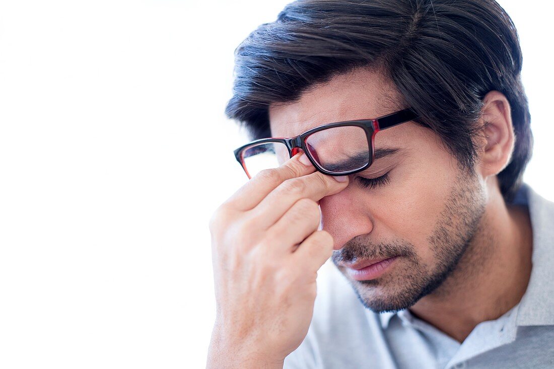 Man pinching the bridge of his nose