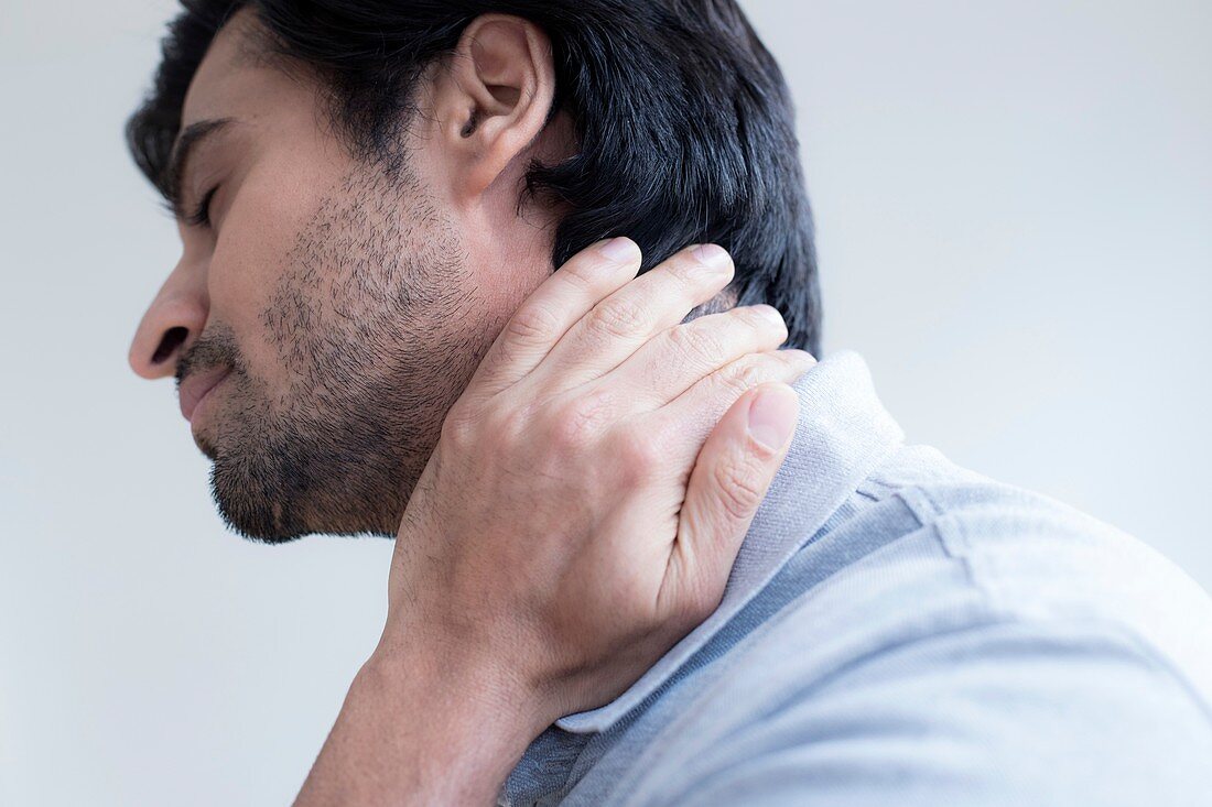 Man touching his neck in pain