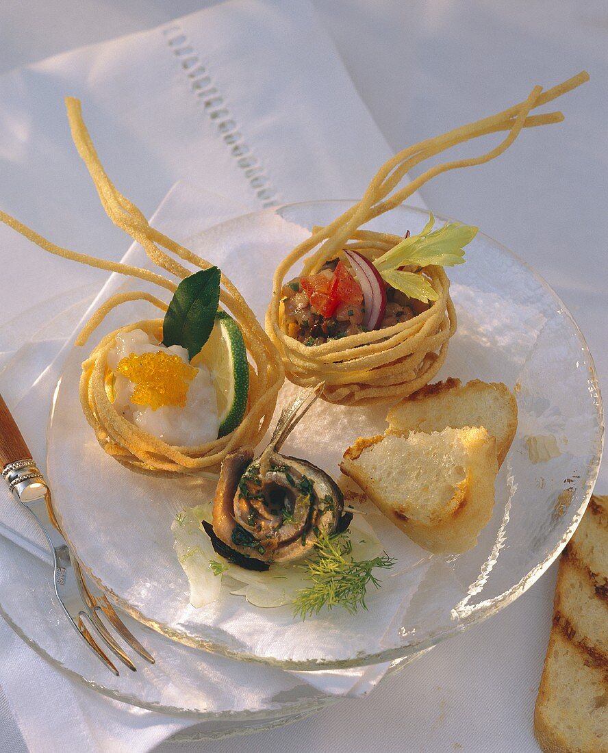 Stuffed fried linguine baskets and marinated sardines