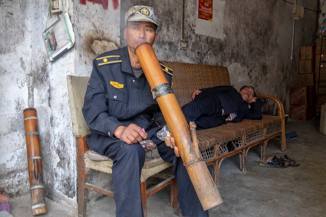 Man smoking water pipe, China