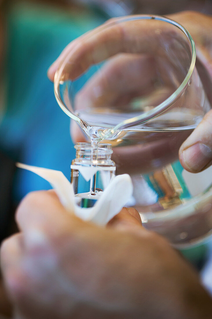 Researcher pouring sample