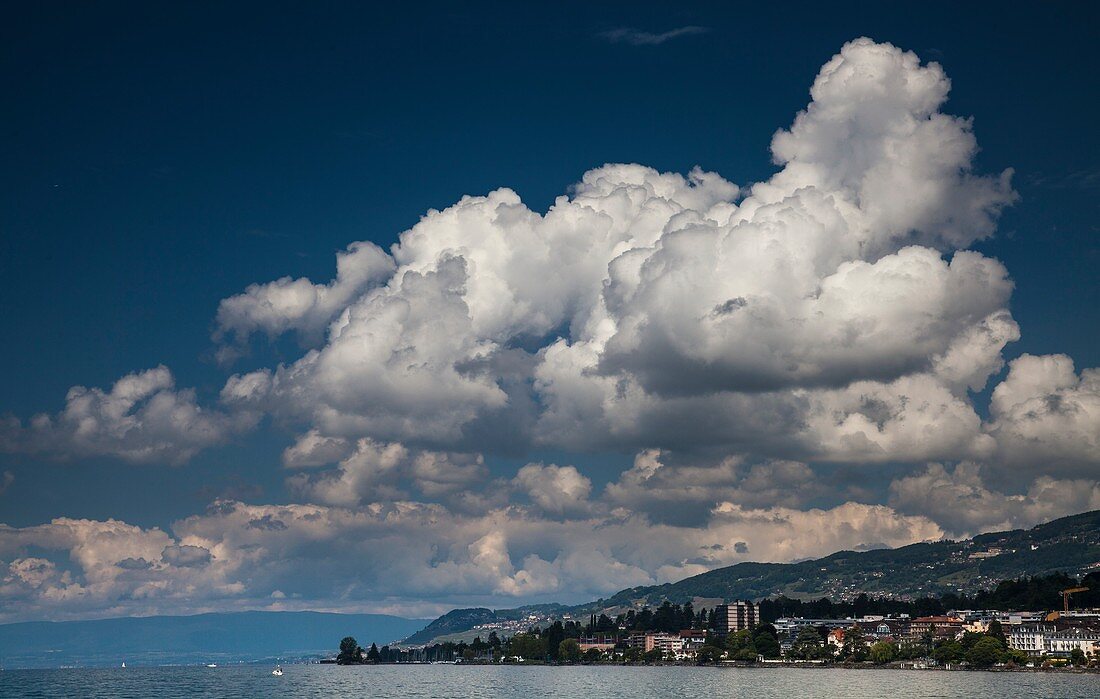 Cumulus mediocris clouds over a lake in Switzerland