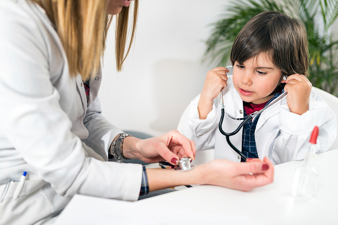 Little boy playing at being a doctor